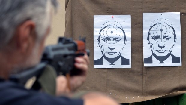 Line of fire: A man shoots at targets depicting Vladimir Putin at a range in the western Ukrainian city of Lviv.