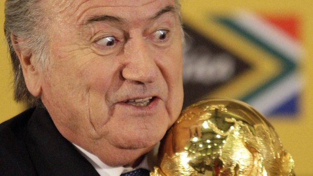 Still hanging around: FIFA President Joseph Blatter holds the Word Cup trophy.