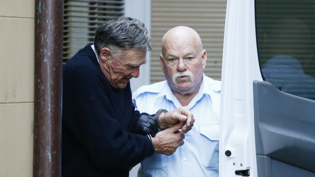 Ian Turnbull, left, is escorted out of court during the trial.