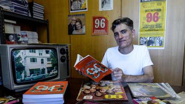 Super-fan: Melbourne historian Nigel Giles with his new book about  <i>Number 96</i>, and some of the memorabilia he has collected.