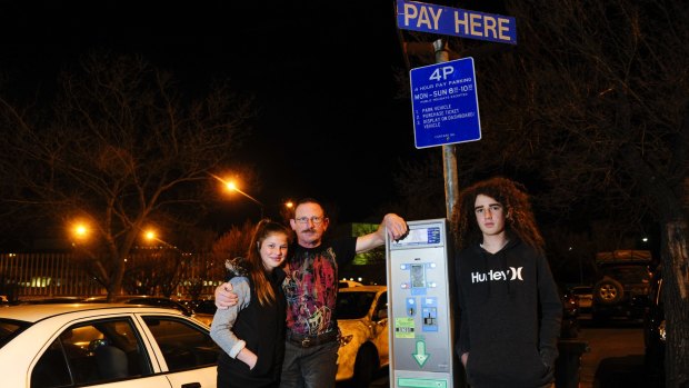 Centre, Alex Humphreys of Stirling with his children, from left, Ellis aged 13 and Caleb aged 15 react to the change to parking fees in city.
