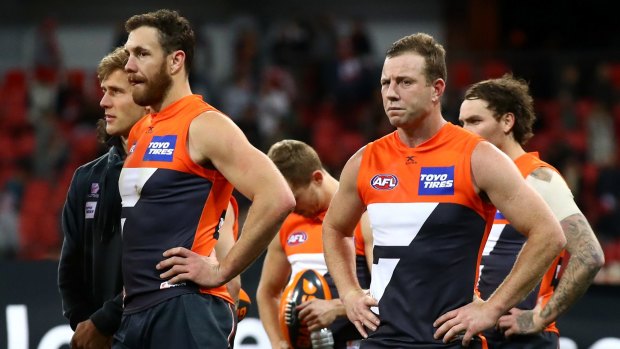 Toppled: Giants Shane Mumford and Steve Johnson after the loss to the Swans.