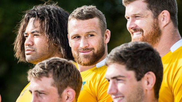 Delighted to be back: Matt Giteau with the team before  their final Rugby World Cup pool A fixture against Wales.