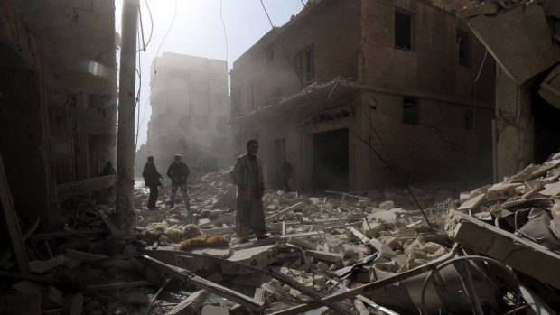 People search for survivors following a reported air strike by Syrian government forces in Aleppo on February 7.