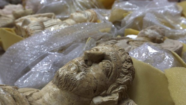 The heads of ancient figures stare at the ceiling of a store in  Damascus where thousands of priceless antiques from across war-ravaged Syria have been gathered for safekeeping.