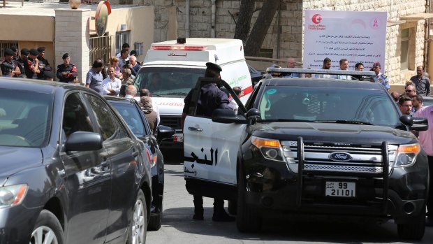 An ambulance transports the body of Nahed Hattar to a medical facility after he was shot dead in front of a courthouse.