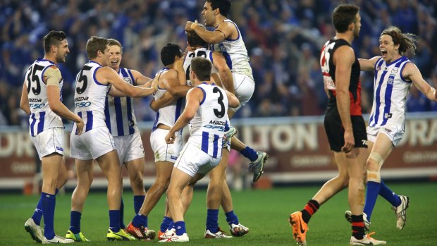 Kangaroos celebrate a crucial goal by Drew Petrie during the second elimination final against Essendon last season.