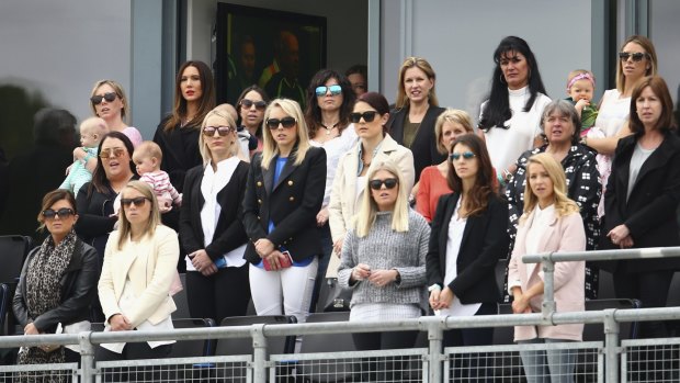 The wives and partners of the Australian team members look on in Cardiff.