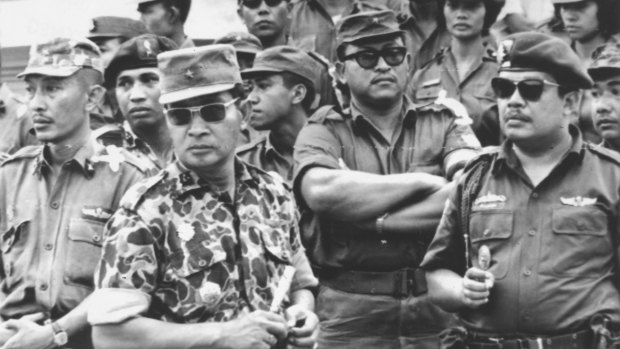 Former Indonesia president Suharto (in patterned uniform) was a major-general in 1965. Here he attends the funeral of the slain generals. He had a leading role in the anti-communist crackdown and massacres that followed.