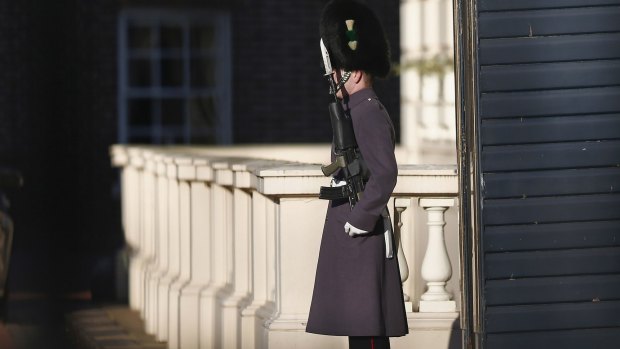 A guardsman stands on duty outside Clarence House.