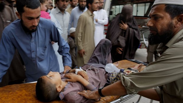 Volunteers in Peshawar transport a boy to hospital following the magnitude-6.6 earthquake.