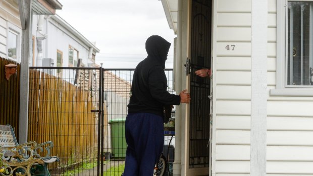 A man visits the Footscray house where Victoria's Joint Counter Terrorism Team was executing a search warrant on Tuesday.
