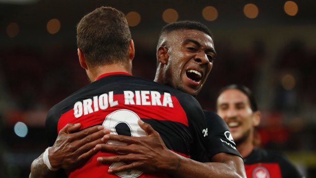 Good start: Oriol Riera celebrates his goal with Roly Bonevacia.