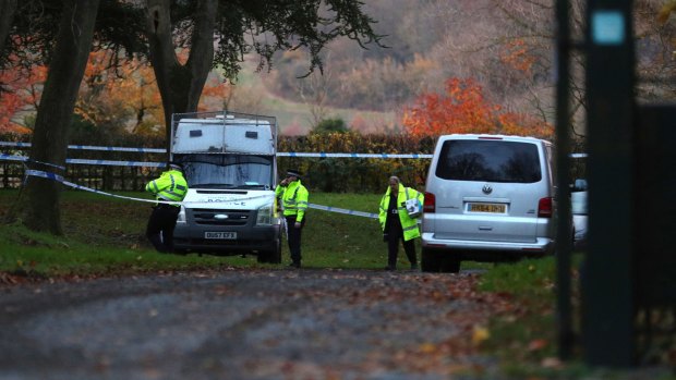 Police patrol the area near the scene of a mid-air collision between a helicopter and an aircraft, in Buckinghamshire.