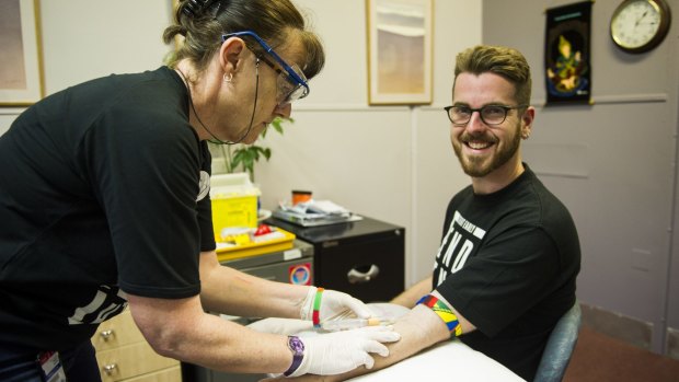 Health check: AIDS Action Council ACT education officer Ben Martin undergoes a sexual health test at the hands of registered nurse Maudie Todkill.