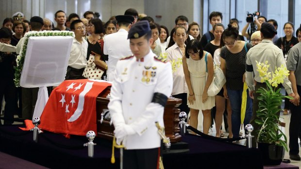 People pay their last respects to the body of Lee Kuan Yew lying in state at Parliament House.