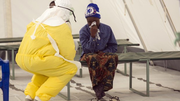 A health worker attends to a suspected Ebola patient in Sierra Leone.