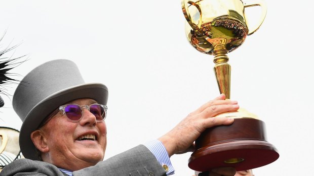 Number five: Lloyd Williams holds up the Melbourne Cup.