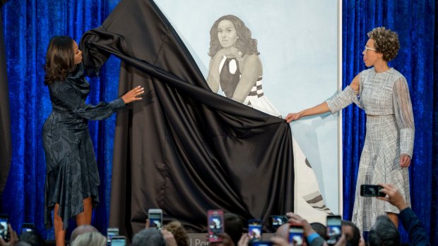 Former first lady Michelle Obama and artist Amy Sherald, right, unveil the official portrait in Washington. 
