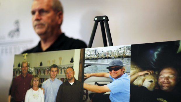 Photos of Chase Sherman are displayed as his father Kevin Sherman attends a news conference.