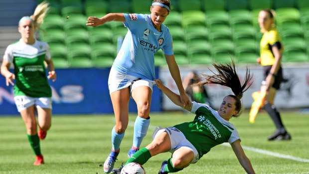 Getting shirty: Canberra's Madelyn Whittall tackles City's Ashley Hatch.