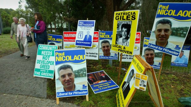 Voters are greeted by political advertising on polling day.