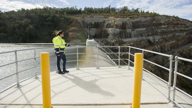 Icon Water community engagement officer Ellen Schwab watching the water spill over the Cotter Dam wall.

