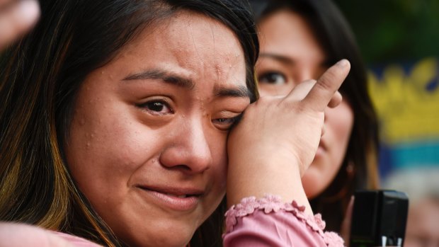 Lizeth Luna wipes away tears as she shares her fears she has after the Trump administration said it would rescind the Deferred Action for Childhood Arrivals Act during a protest in Nashville, Tennessee. 