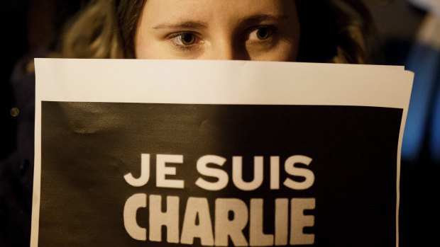 A woman holds a placard reading "Je Suis Charlie" (I am Charlie) during a gathering in Spain for the victims of the terrorist attack at French magazine Charlie Hebdo.