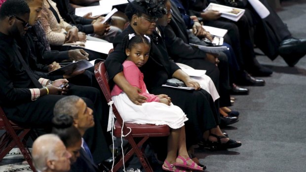 Malana Pinckney, daughter of the Reverend Clementa Pinckney, is hugged by her mother Jennifer at her father's funeral in Charleston, South Carolina on June 26.