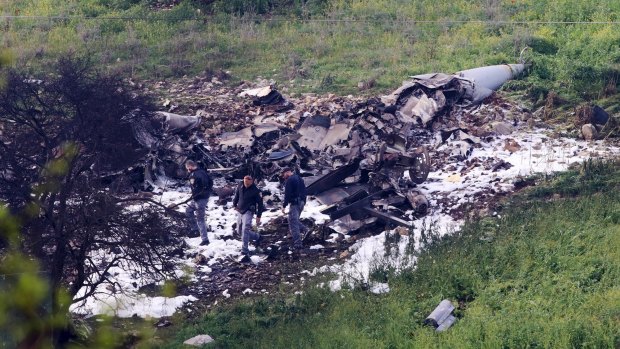 Israeli security stands around the wreckage of an F-16 that crashed in northern Israel earlier this month. Netanyahu's difficulties come at a time of high tension in the region.