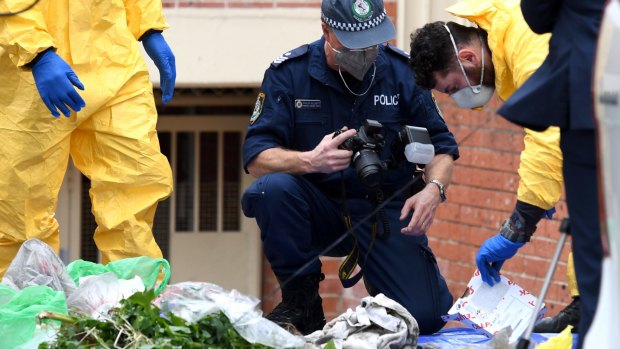 Police examine items outside Khaled Khayat's Lakemba unit as part of their investigation into an alleged terrorism plot.