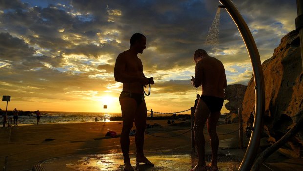 Swimmers rinse off at Clovelly Beach before the temperatures rise in Sydney on Tuesday morning.