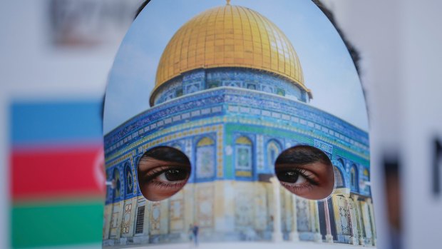 A protester wearing a mask with Jerusalem's Dome of the Rock Mosque participates in a rally against US President Donald Trump's decision to recognise Jerusalem as the capital of Israel.