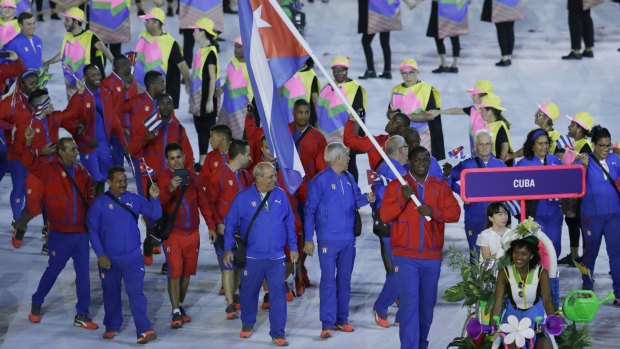 Mijain Nunez Lopez carries the flag of Cuba during the opening ceremony for the 2016 Summer Olympics in Rio de Janeiro, Brazil, Friday, Aug. 5, 2016.