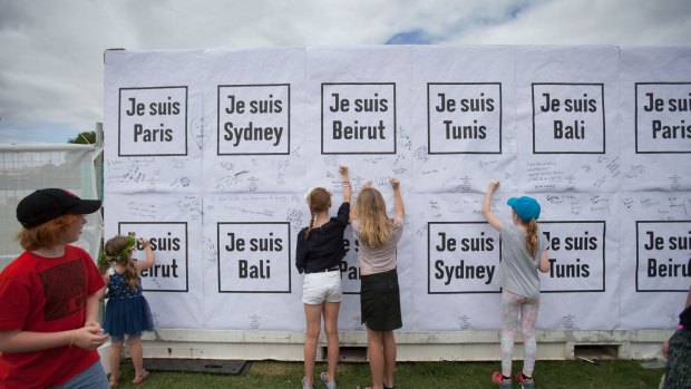Festival goers write notes to the French at the So Frenchy so Chic in the Park.