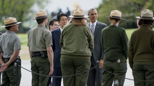 Mr Obama, right, and Mr Abe talk to park rangers at the Lincoln Memorial in Washington.