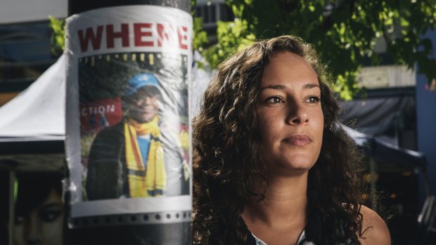 Rezina Kahsai with missing posters for her father, Tad Kahsai, who has been missing since December 30.  