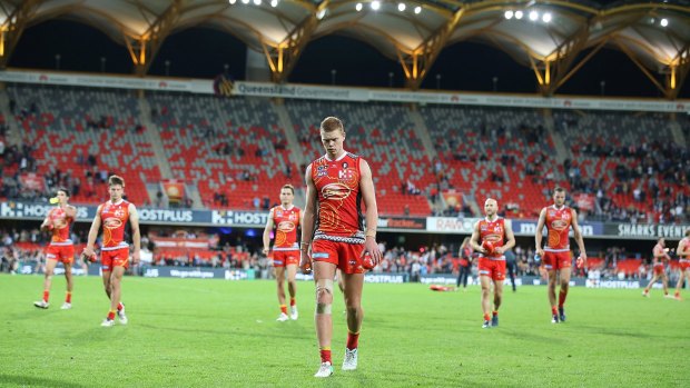 Sunset: Gold Coast leave the field after losing to Carlton.