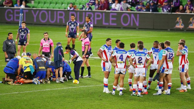 The night it all went wrong: Alex McKinnon is treated after the tackle that left him with a major spinal injury.