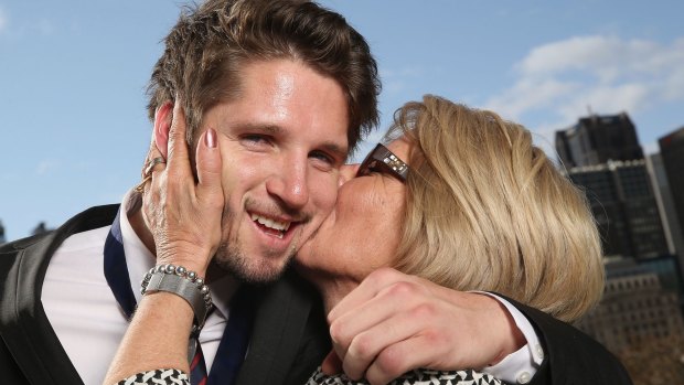 Jesse Hogan of the Demons is kissed by his mum Julie Hogan after winning the 2015 AFL Rising Star.