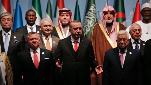 Turkish President Recep Tayyip Erdogan, centre, flanked by Jordanian King Abdullah II, left, and Palestinian President Mahmoud Abbas, right, prior to the opening session of the Organisation of Islamic Cooperation Extraordinary Summit in Istanbul, on Wednesday.