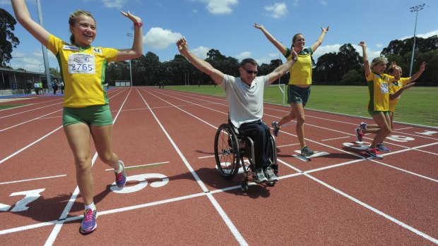 The $7m refurbishment of the Woden athletics track. Commonwealth Games medalist in the Javelin, Kelsey-Lee Roberts, centre, is joined by Woden Little Athletics club members from left Rori Pryor, 11, Adela Russell, 11 and Siena Russell, 10. and paralympian, Richard Nicholson, at the track.