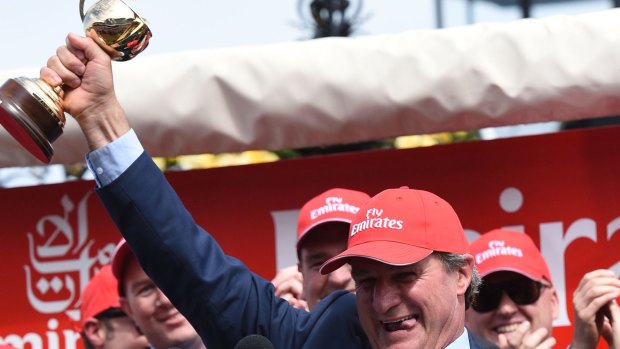 Trainer Darren Weir poses with the trophy after Prince of Penzance won the Melbourne Cup. 