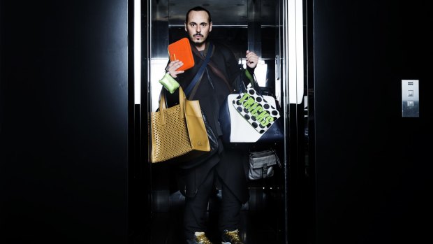 Boys keep swinging: Fashion stylist Fernando Barraza with a selection of man bags.