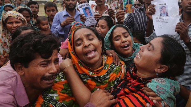 Relatives of a Bangladeshi garment worker killed in the Rana Plaza factory collapse mourn as they collect his body.