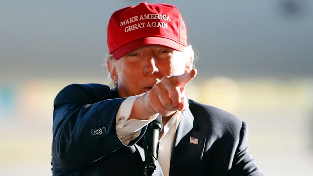 Red hot rage: Republican presidential candidate Donald Trump points to the media as he addresses the crowd during a campaign stop at the Minneapolis International Airport on Sunday.