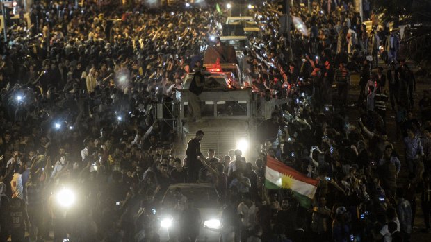Hearty welcome: People line the streets to greet peshmerga convoys in Sanliurfa, Turkey.