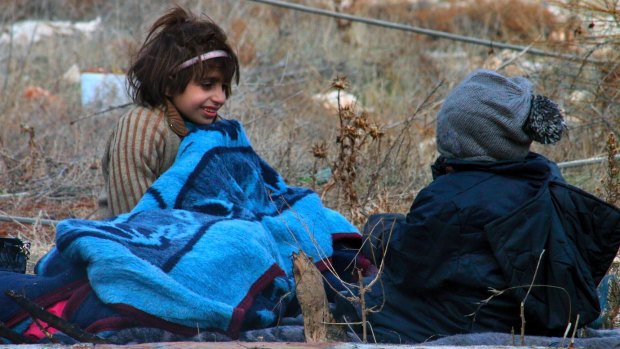 Children of eastern Aleppo sitting on the ground in western rural Aleppo, Syria.