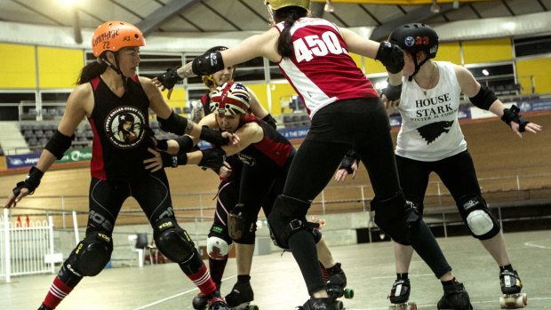 Roller Derby teams training together at the Dunc Gray Velodrome in Bass Hill.